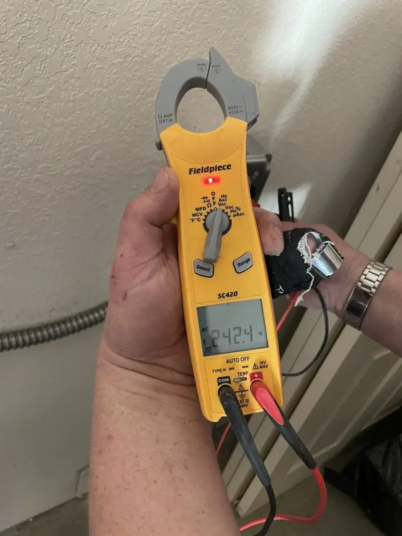 Voltage testing with clamp meter during Outlet Installation in Danville